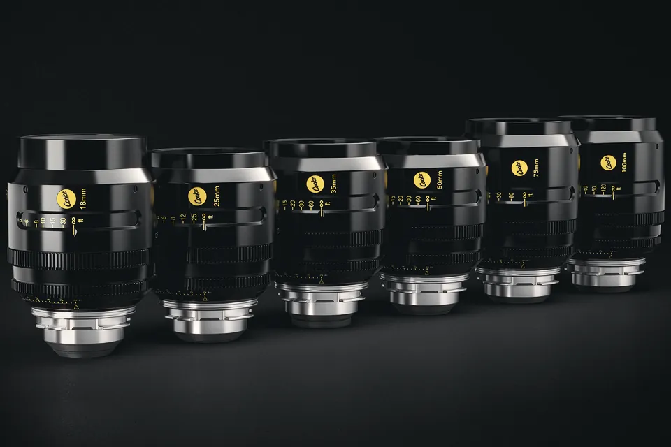 The six Cooke S4 FF/i primes, 18mm to 100mm, lined up on a black background with their gold Cooke badges and PL mounts