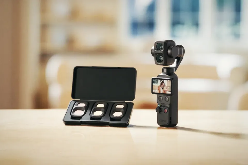 The DJI Osmo Pocket 4P standing on a wooden table next to its open ND filter case, with three filters inside