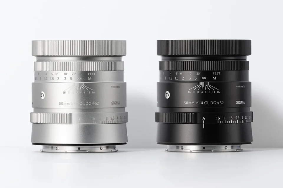 The Sigma 50mm F1.4 CL DG lens in silver and black, side by side