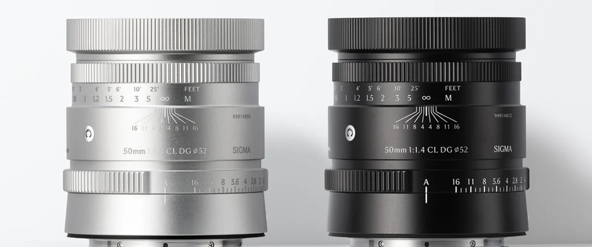 The Sigma 50mm F1.4 CL DG lens in silver and black, side by side