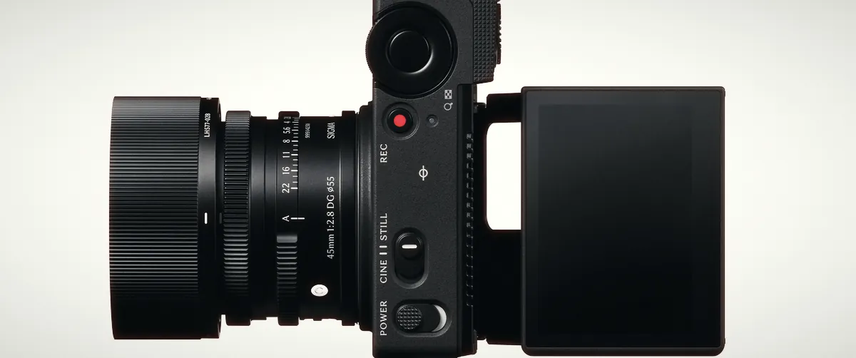 Top view of the Sigma FP2 with a 45mm lens, showing the CINE/STILL switch, the red REC button and the tilted rear screen